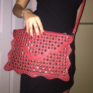 Red clutch with adjustable strap